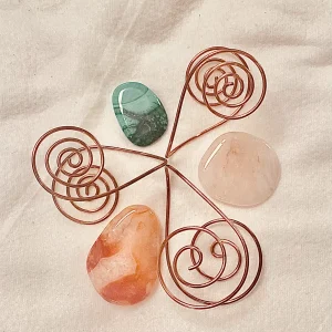Étoile de spirales en cuivre entrelacées portant des pierres naturelles – plateau énergétique fait main